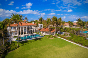alt="Mansion with a pool and expansive backyard links to South Florida luxury homes for sale."