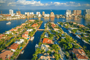 alt="aerial of homes on canals and oceanfront condos links to waterfront homes for sale."